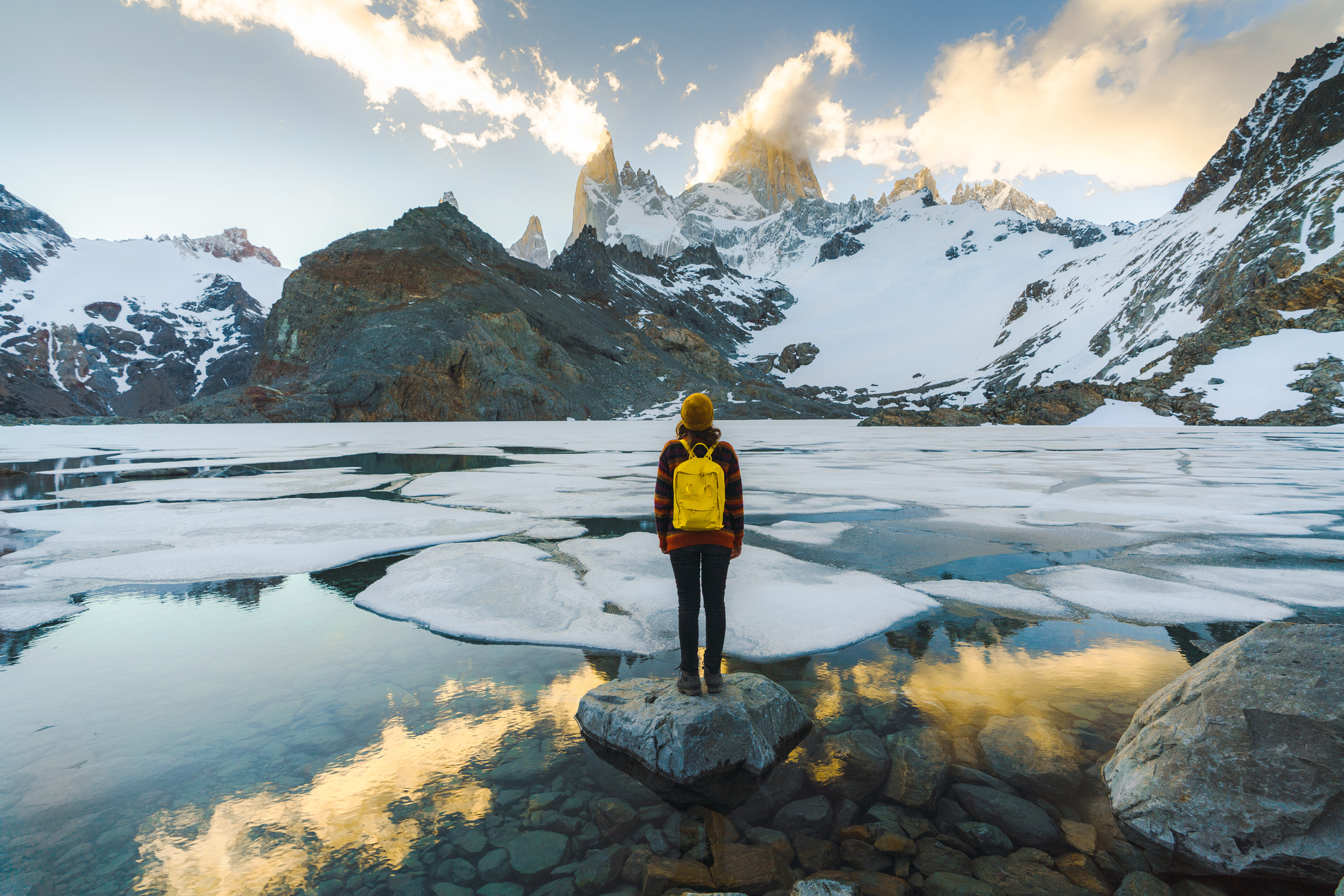 Young Caucasian woman standing and looking at Fitz Roy mountain in Patagonia
